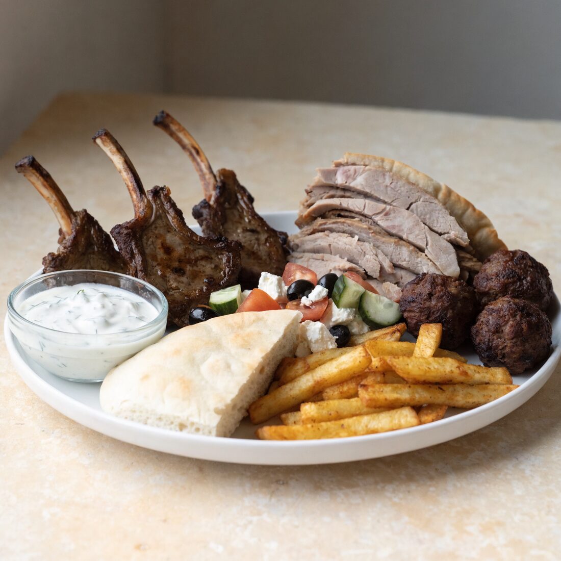 Succulent lamb chops, house made keftedes and savory strips of gyro meat